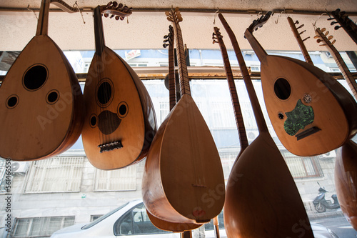 Handmade Oud hanging inside the window display of Muzik Evi, Istanbul. Bağlama and Oud. Turkish musical instruments  photo