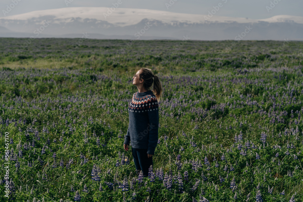 girl in a sweater on the background of the mountains in iceland
