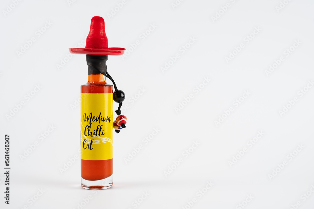 bottle of medium chilli infused oil isolated on a white background bottle of medium chilli infused oil isolated on a white background