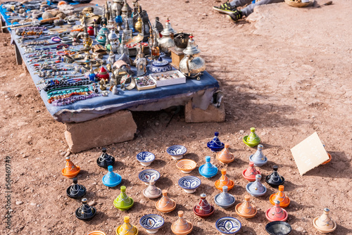 A colorful Moroccan market scene along a bustling street selling handcrafted goods