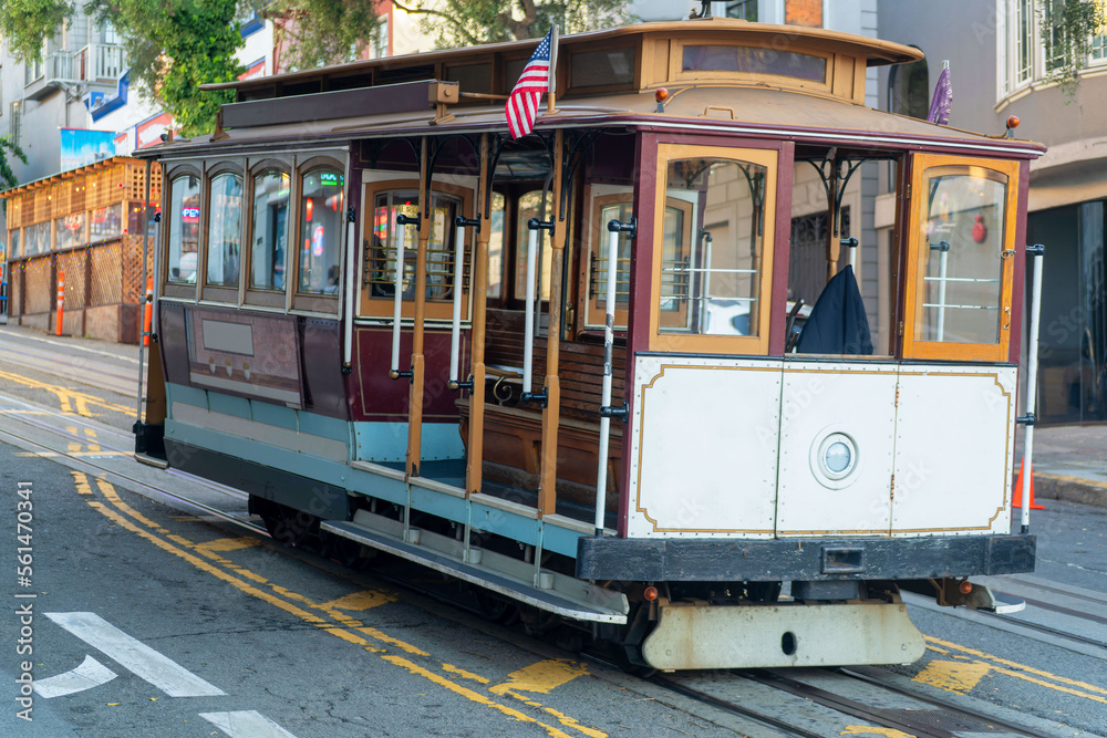 Naklejka premium Cable car in historic districts in san francisco california deep in heart of city with white color and wooden accents