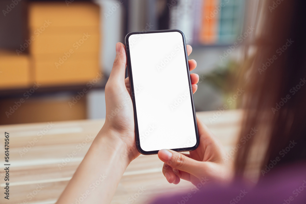 Hand holding digital smartphone mockup of blank screen. Take your screen to put on advertising.