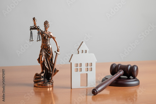 Lady Justice, Judge gavel and house. Concept of real estate auction or dividing house when divorce, division of property, real estate, law system. photo