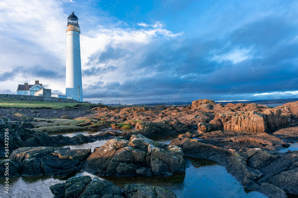 Fototapeta premium Lighthouse on the coast of the North Sea in Scotland against a dramatic sky