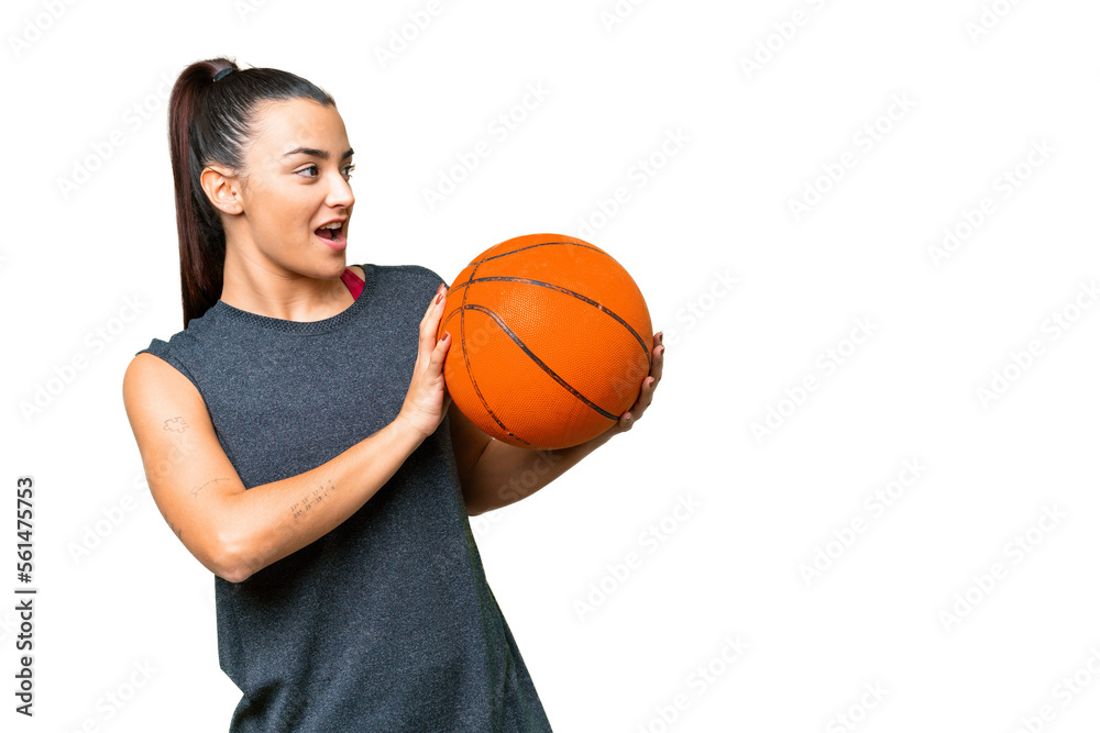 Young beauty woman over isolated chroma key background playing basketball Young beauty woman over isolated chroma key background playing basketball