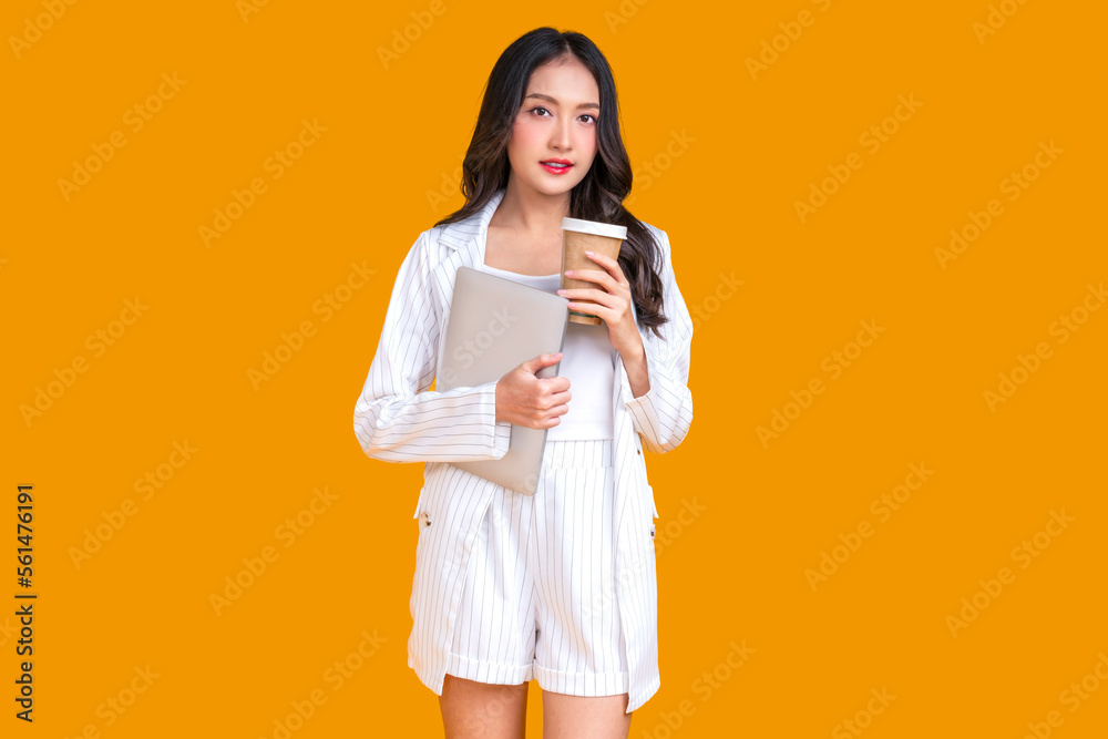 asian smart attractive female woman wear formal cloth business look standing with confident and cheerful positive smile hand hold smartphone and coffee paper cup studio shot on yellow background asian smart attractive female woman wear formal cloth business look standing with confident and cheerful positive smile hand hold smartphone and coffee paper cup studio shot on yellow background