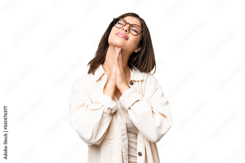 Young Russian woman over isolated chroma key background keeps palm together. Person asks for something Young Russian woman over isolated chroma key background keeps palm together. Person asks for something
