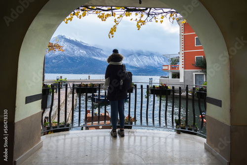 A girl looks at Lake Garda from a porch in Limone sul Garda