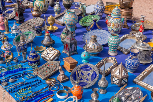 A colorful Moroccan market scene along a bustling street selling handcrafted goods
