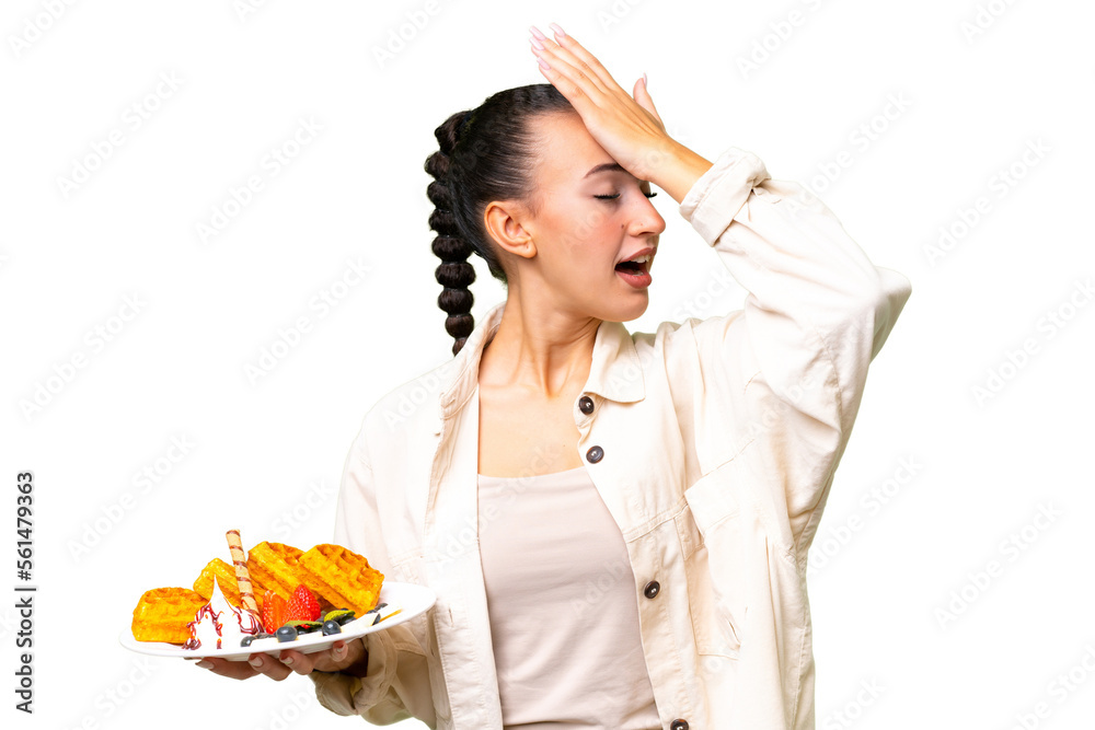 Young Arab woman holding waffles over isolated background has realized something and intending the solution Young Arab woman holding waffles over isolated background has realized something and intending the solution