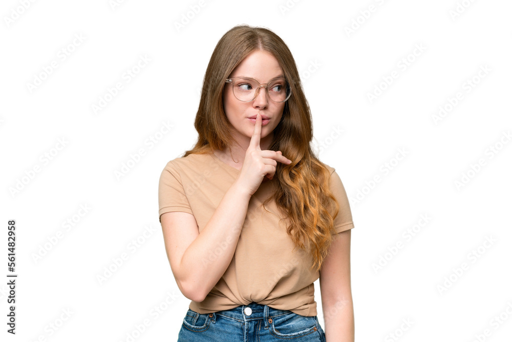 Young pretty woman over isolated background showing a sign of silence gesture putting finger in mouth Young pretty woman over isolated background showing a sign of silence gesture putting finger in mouth