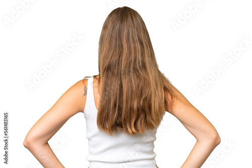 Young pretty woman over isolated background in back position