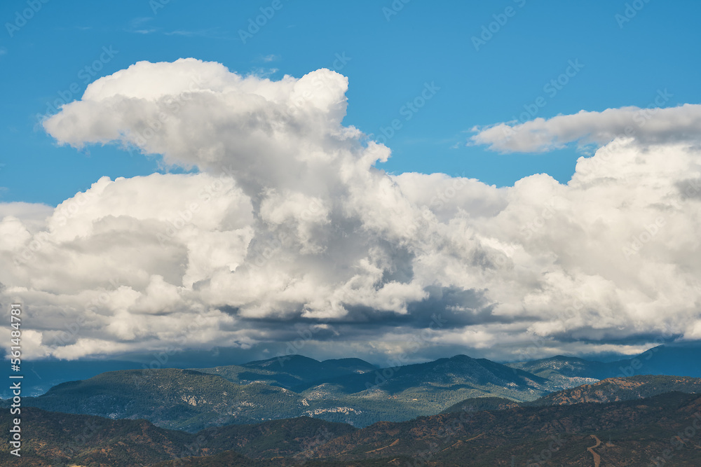 Beautiful view of cumulus clouds over old mountains in Antalya on the Aegean coast, idea for a background, travel and vacation story