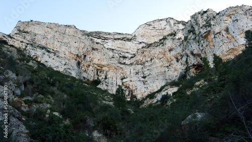 White mountain, sheer cliffs, stones, mountain vegetation, pine trees, beautiful unique landscape, Mount Montgo in Spain Alicante