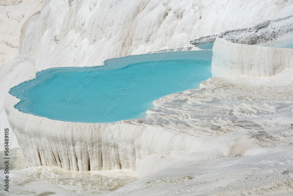 Beautiful aqua blue pools of natural mineral rich spring water with many healing properties in beautiful Pamukkale , the cotton castle of western Turkey, a major Turkish tourist destination