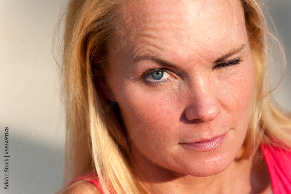 Close up of a 40 year old blond woman making a face at the camera. Close up of a 40 year old blond woman making a face at the camera.
