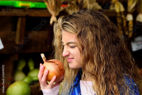 Girl smelling onion, Benton, Pennsylvania, USA