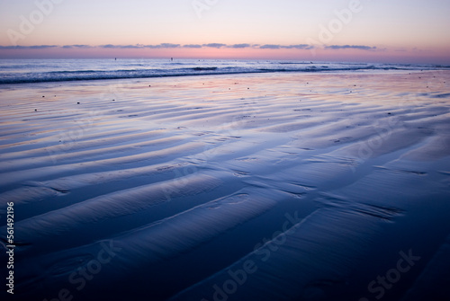 Ripples in the wet sand on a beach at sunset. Encinitas, California. photo