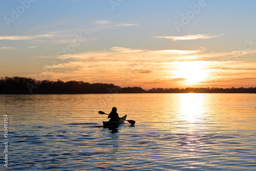 Silhouette of woman kayaking on river at golden sunset. Active recreation, healthy lifestyle and care about mental health, resting in privacy and peace © watcherfox