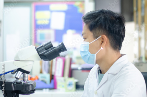 Asian scientists working in laboratory.