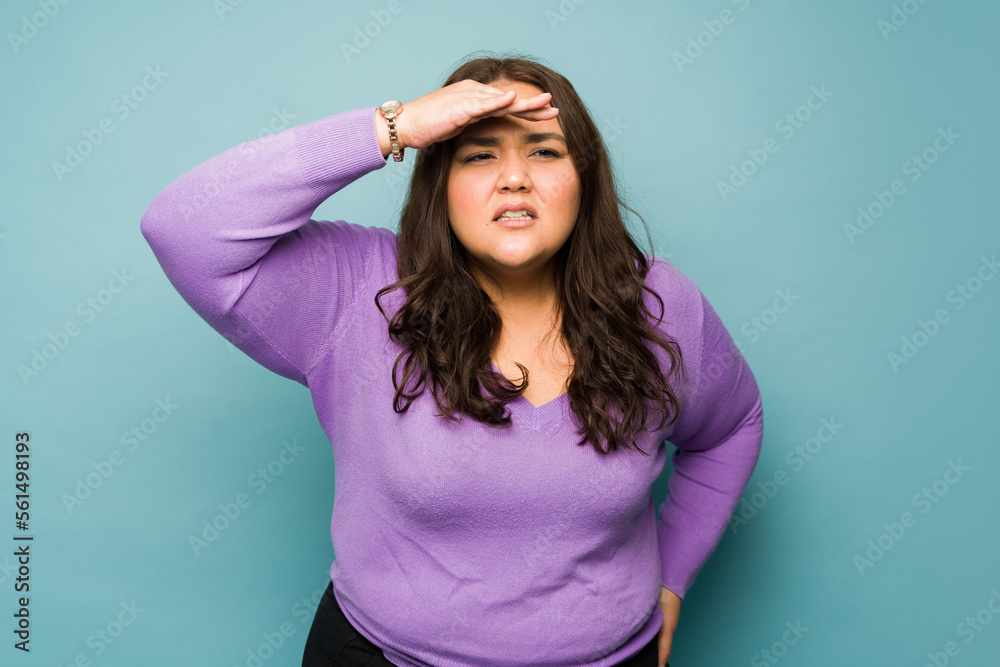 Hispanic fat woman having eye vision problems Hispanic fat woman having eye vision problems