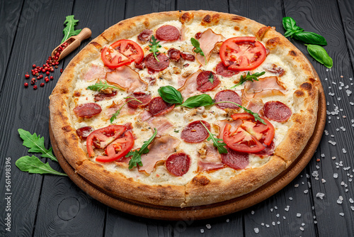 Pizza with mozzarella cheese, salami and chicken meat