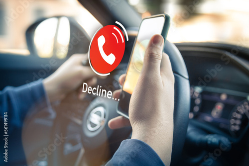 Teenager receiving a phone call during driving a car. Security, technology, communication concept. photo