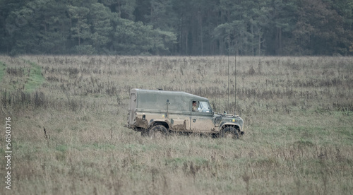 dirt covered vehicle driving across a field 