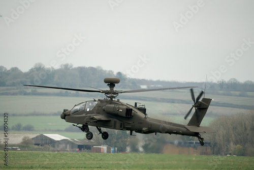close-up of a British army AH-64E Boeing Apache Attack helicopter (ZM722 ArmyAir606) in a low hover on a military exercise, Wilts UK