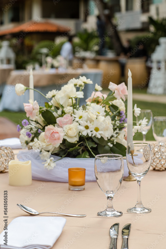 Beautiful table setting with tableware, flowers, candles and accessories for a party, wedding reception, gala banquet or other holiday event.