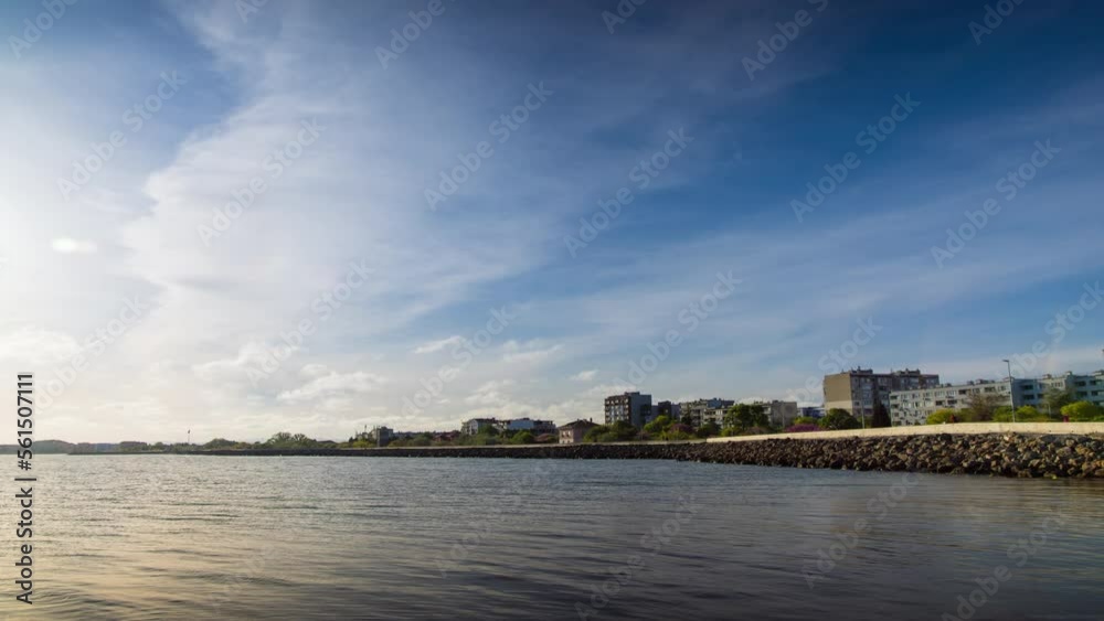 Embankment with stones passes over the Black sea against the backdrop of a sunny sky Embankment with stones passes over the Black sea against the backdrop of a sunny sky