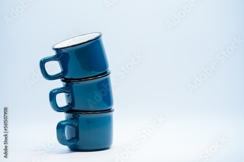 close-up of three blue ceramic glazed coffee cups