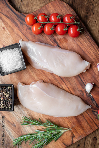 raw chicken fillet on wooden background photo