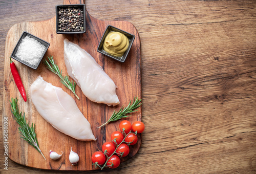 raw chicken fillet on wooden background with copy space for your text photo