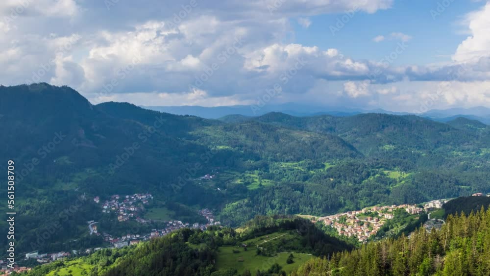 View from rock to town of Smolyan with meadows for cattle walking and houses between mountain range of Rhodope Mountains View from rock to town of Smolyan with meadows for cattle walking and houses between mountain range of Rhodope Mountains