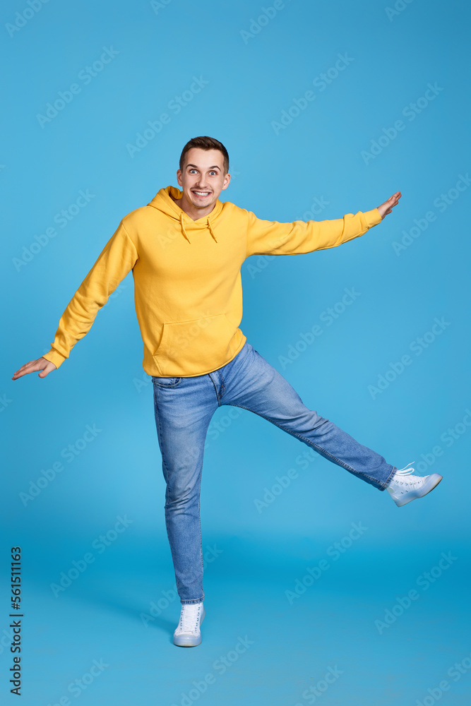 young happy man in casual clothes jumping