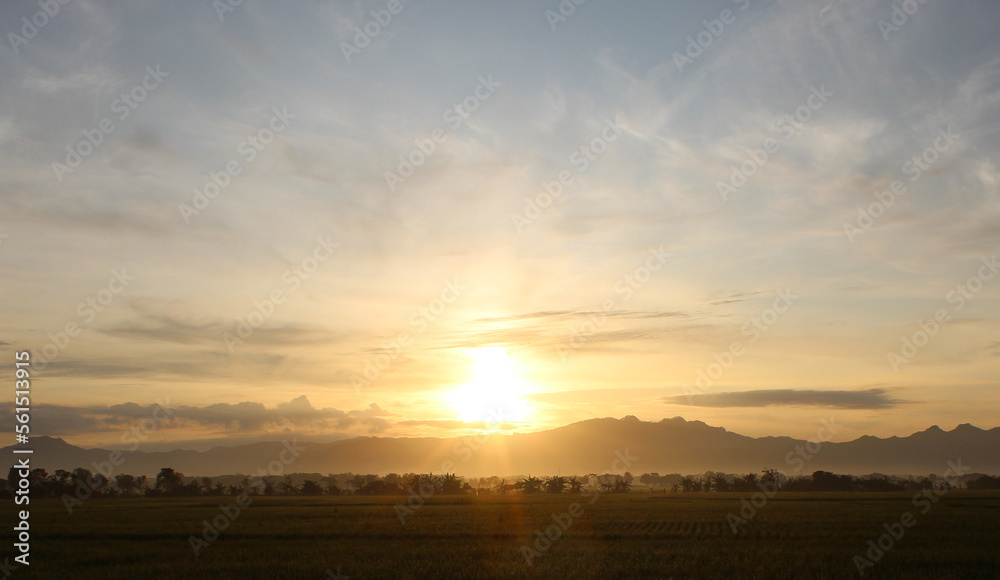 Scenery of golden hour, sunrise, mountains, trees and golden sky