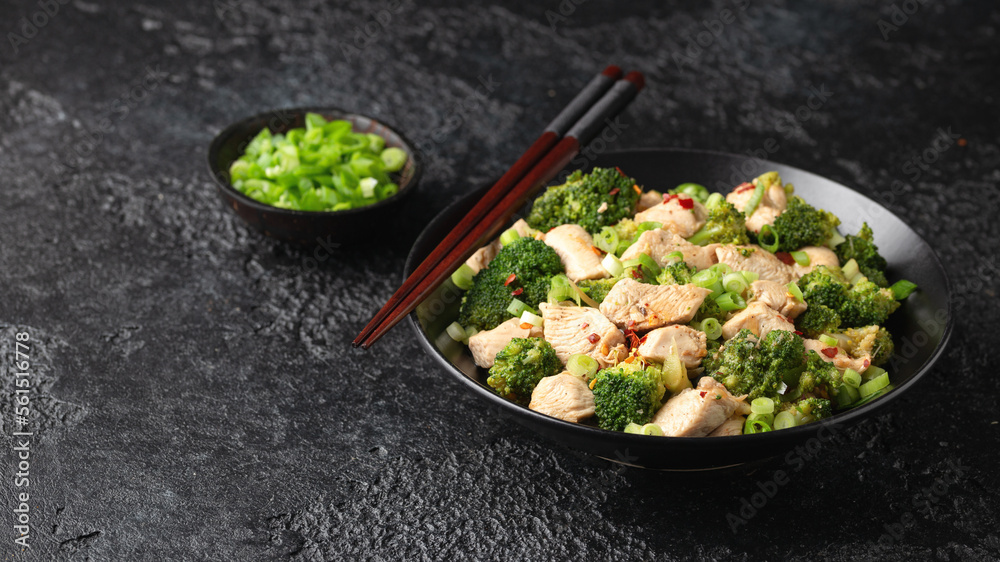 Stir fried Chicken and Broccoli in black bowl Stir fried Chicken and Broccoli in black bowl