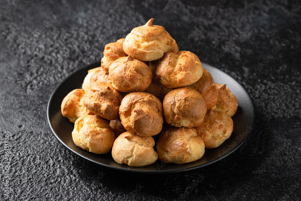 Savoury profiteroles stuffed with Molten cheddar cheese sauce, party food concept