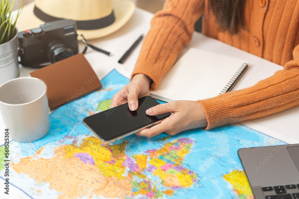 Travel planning, vacation, holiday trip, asian young tourist woman, girl hand using mobile phone, cellphone book flight ticket or check in online with passport, preparation for journey voyage trip. Travel planning, vacation, holiday trip, asian young tourist woman, girl hand using mobile phone, cellphone book flight ticket or check in online with passport, preparation for journey voyage trip.