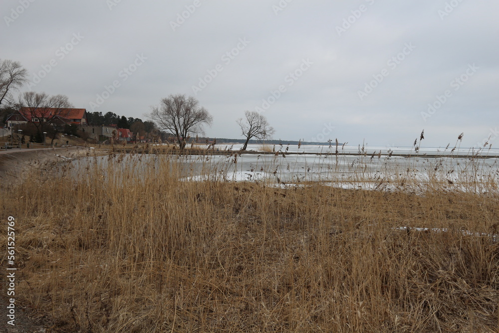 seashore with sandy beach in spring with melted snow seashore with sandy beach in spring with melted snow