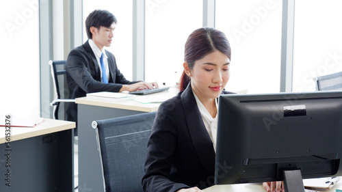 Young female employee working at a desk using a computer to work business idea.