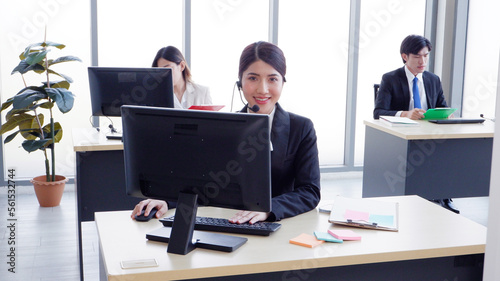Call center female employee sitting at the desk.