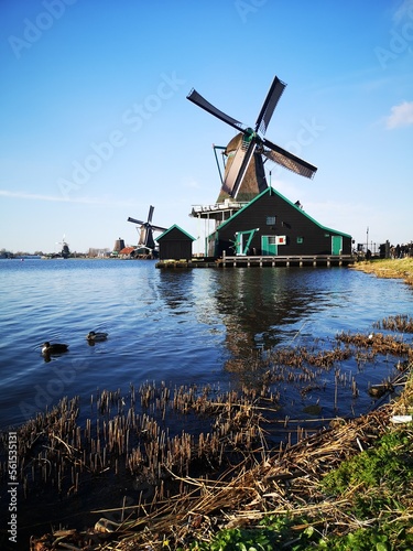 DUTCH MILLS ON THE BLUE LAKE AT SUNSET