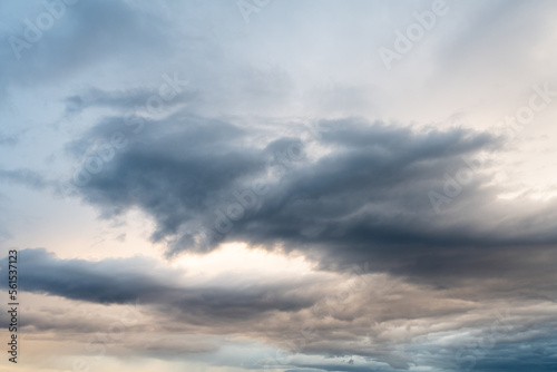 Cloudscape of grey bluish clouds in a stormy golden sky