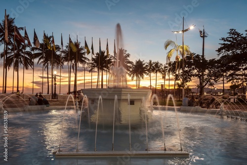 9 de Julho water fountain, Praça das Bandeiras, Gonzaga beach. City of Santos, Brazil. Sunset on the beach. photo