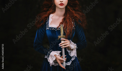 Fantasy woman warrior on black background, lady with red lips, long hair hands close up holding dagger, knife short sword. Girl gothic princess witch. Vintage blue dress old style. Art cropped face 