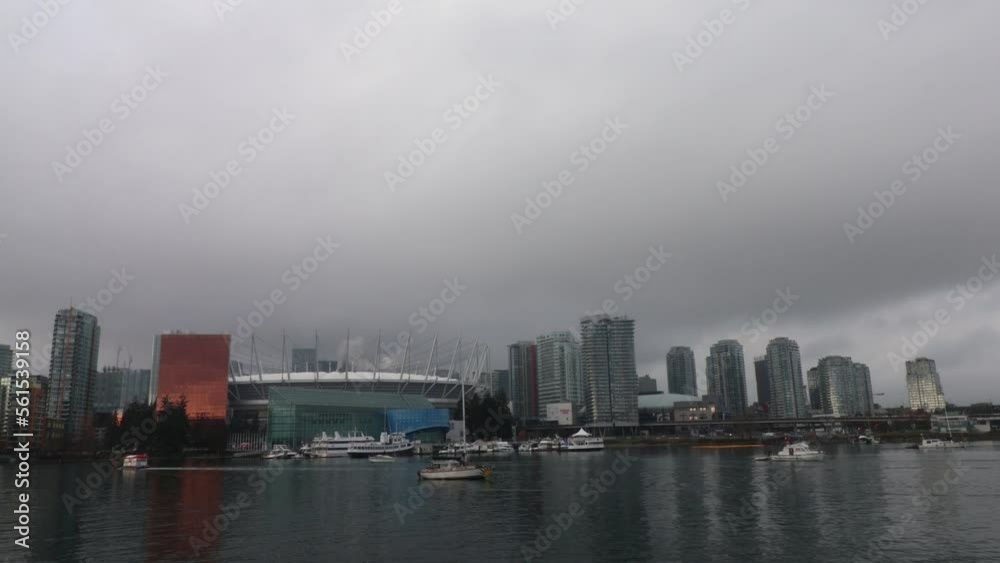 Timelapse of Vancouver downtown on an overcast day with boats passing by Timelapse of Vancouver downtown on an overcast day with boats passing by