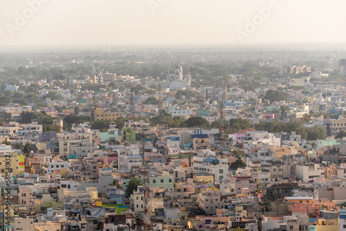 An aerial cityscape of low rise buildings in the town of Trichy in Tamil Nadu, India.