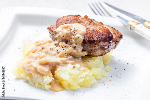 grilled meat with mashed potatoes with onion sauce